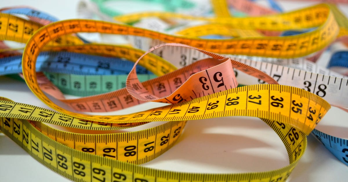 A group of retractable tape measures arranged together.